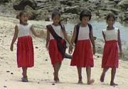 Primary school girls on beach in Samoa
